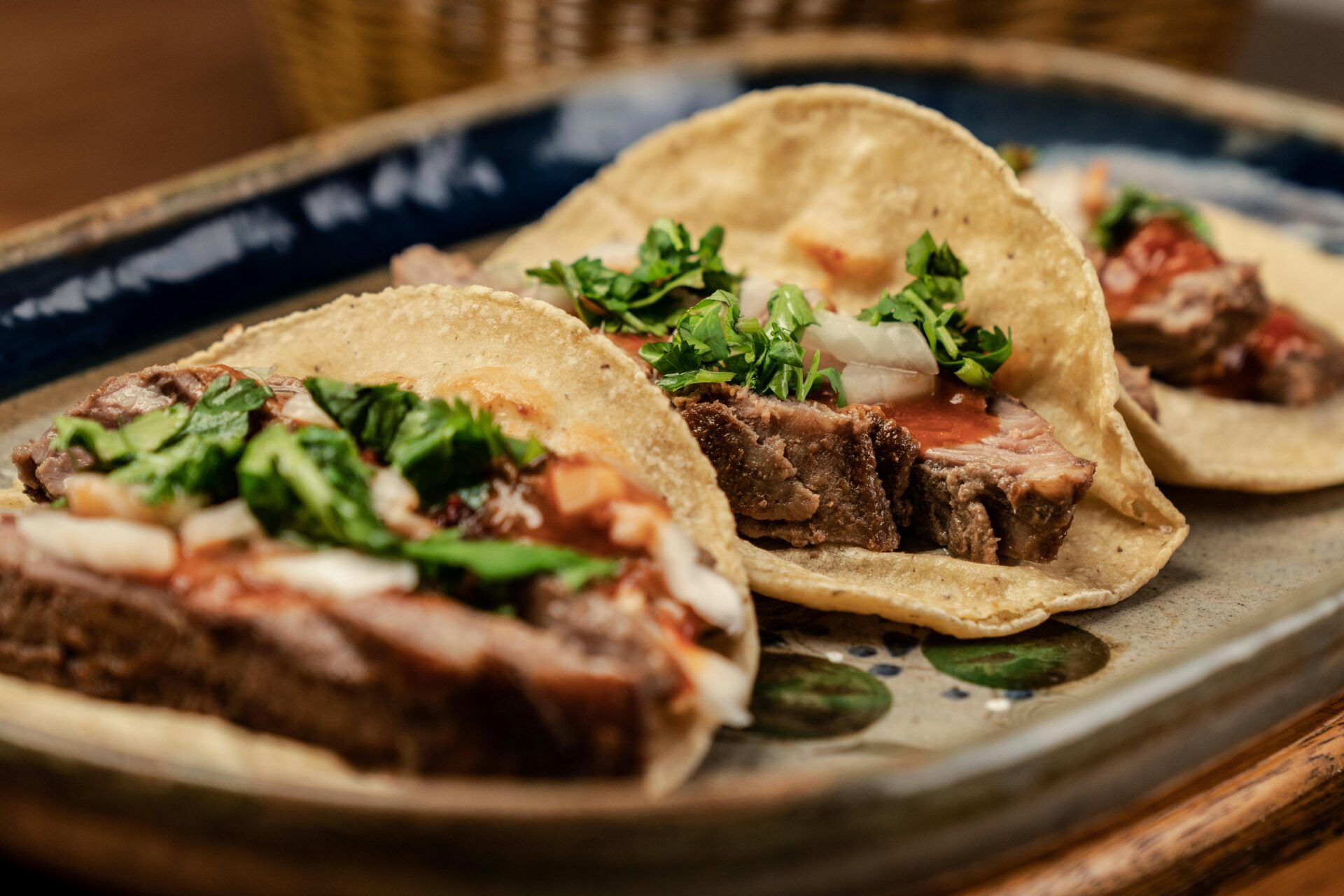 A closeup of three steak tacos.